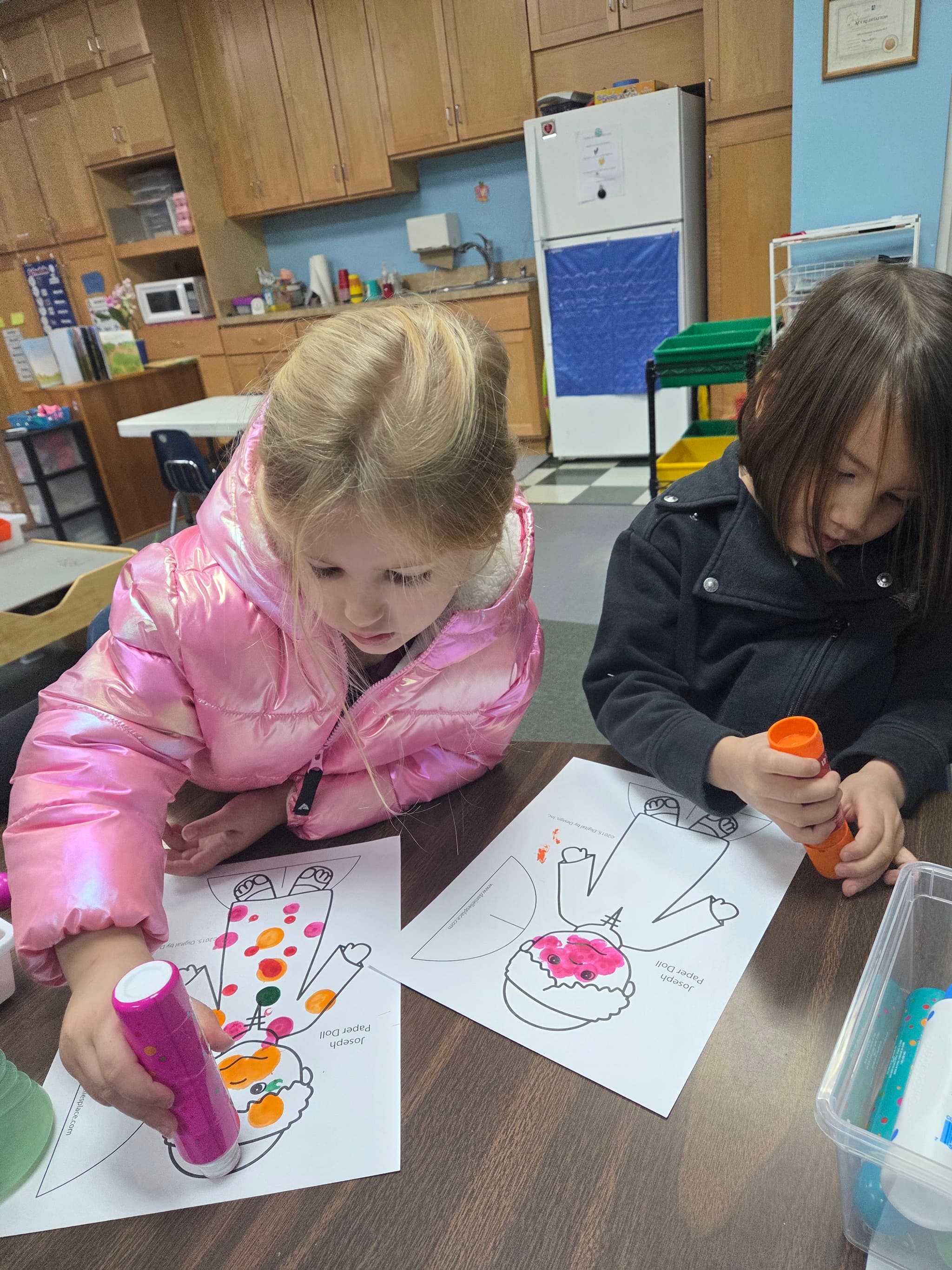 Students doing dot painting crafts in the classroom