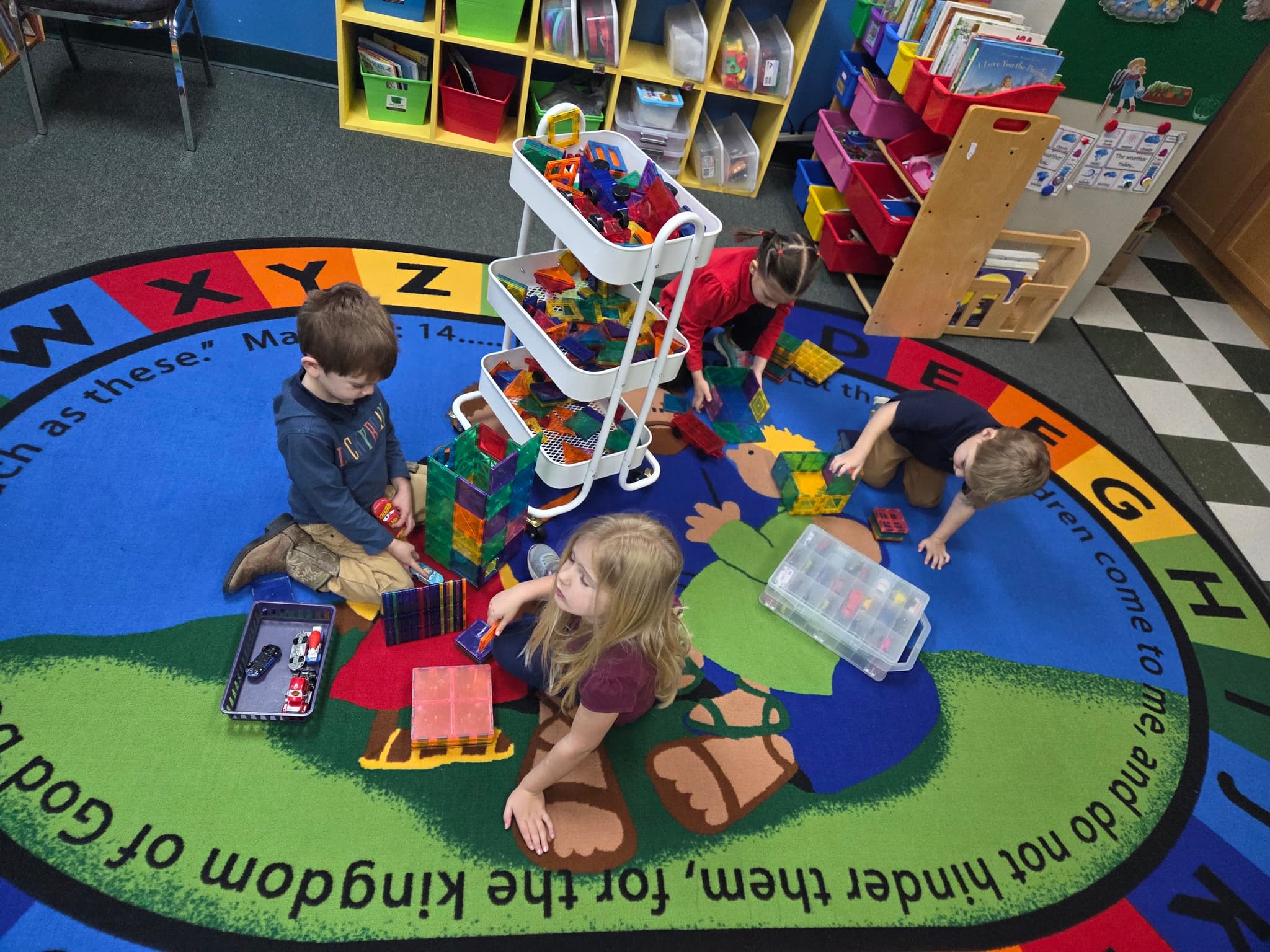 Students building with magnetic tiles in the classroom