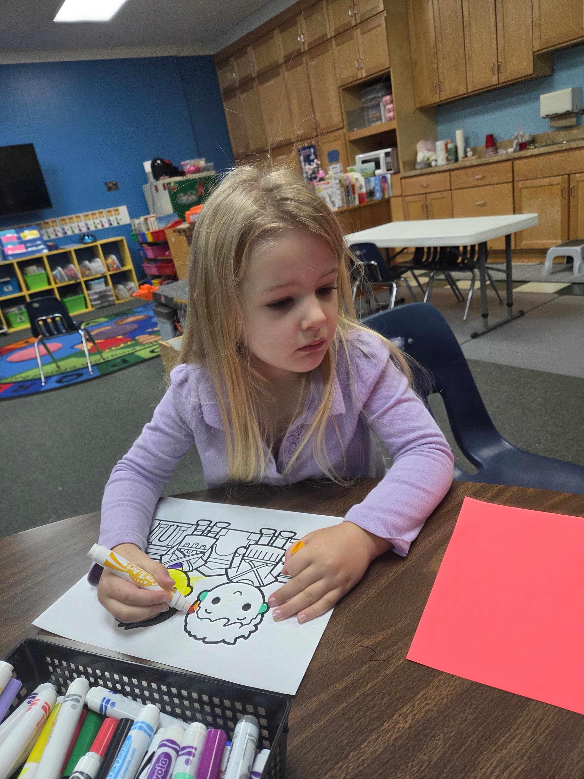 Student coloring at her desk